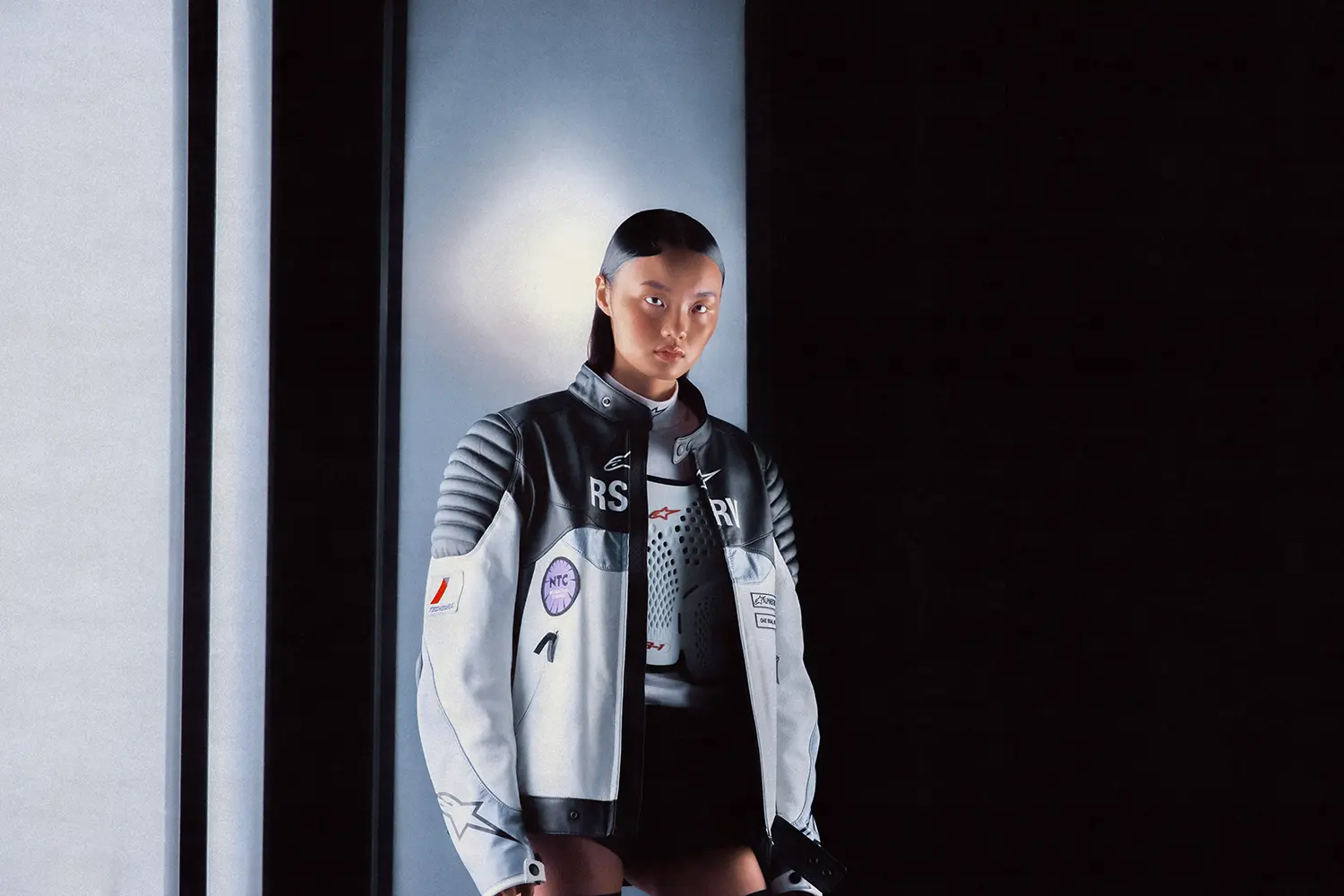 Model wearing a black-and-white jacket from the Alpinestars RSRV collection