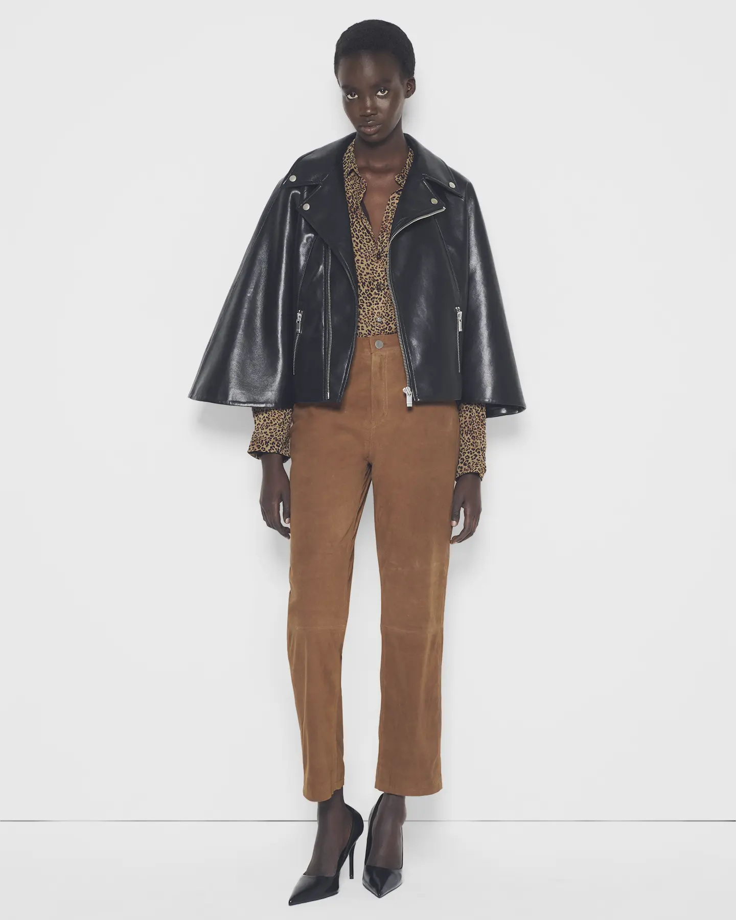 Studio product shot of a model wearing a recycled leather moto cape