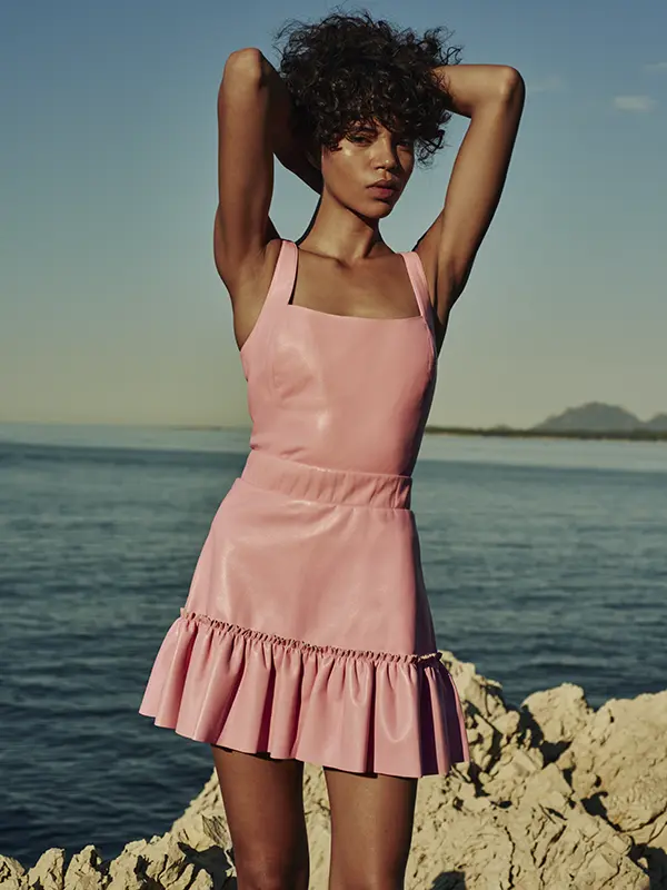 Model wearing a pink dress photographed by the sea for As by DF